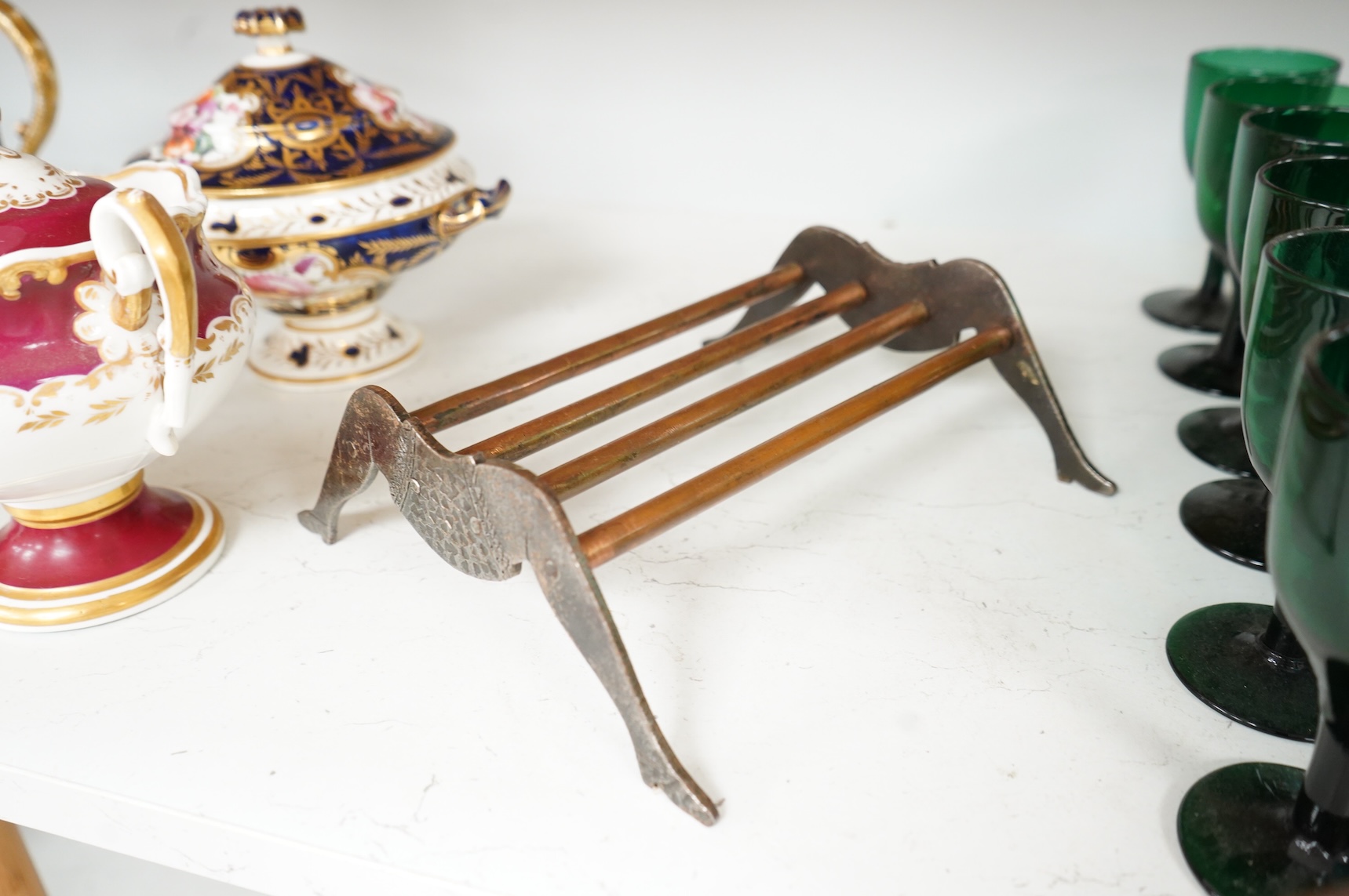 An engraved iron and copper novelty lady's legs stand, 21cm wide